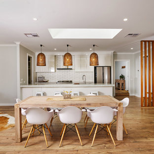 Country open plan dining in Other with medium hardwood floors, brown floor and grey walls.