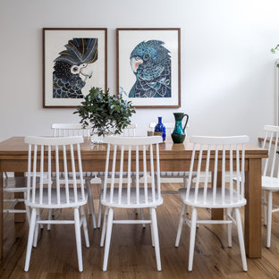 Inspiration for a small country open plan dining in Melbourne with white walls, no fireplace, medium hardwood floors and brown floor.