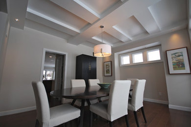 Medium sized modern enclosed dining room in Edmonton with white walls, medium hardwood flooring, no fireplace and brown floors.