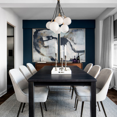 Example of a small trendy dark wood floor enclosed dining room design in New York with blue walls and no fireplace