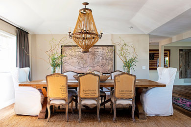 Example of a huge mountain style light wood floor great room design in San Diego with beige walls and no fireplace