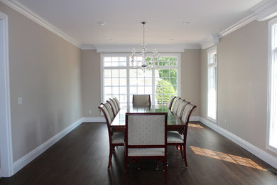 Example of a large transitional dark wood floor dining room design in New York with beige walls