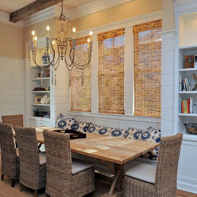 Example of a mid-sized beach style medium tone wood floor kitchen/dining room combo design in Miami with yellow walls