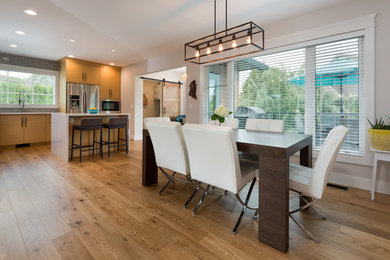 Inspiration for a modern medium tone wood floor and beige floor dining room remodel in Vancouver with gray walls and no fireplace