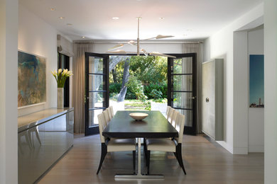 Dining room - large contemporary light wood floor dining room idea in Los Angeles with white walls and no fireplace