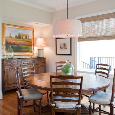 Example of a large classic medium tone wood floor kitchen/dining room combo design in Houston with beige walls