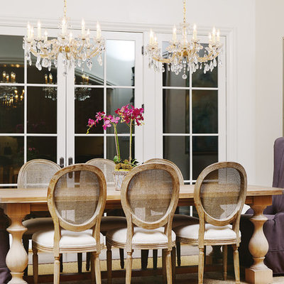 Inspiration for a large timeless medium tone wood floor enclosed dining room remodel in Raleigh with white walls