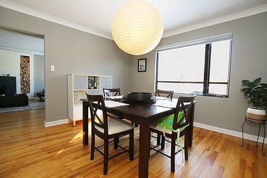Example of a mid-sized minimalist light wood floor enclosed dining room design in Ottawa with gray walls and no fireplace