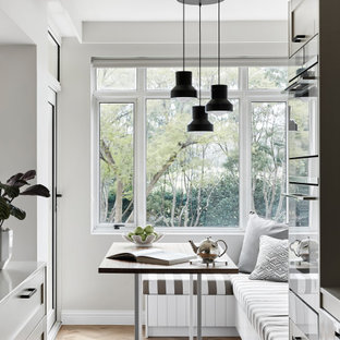 Design ideas for a mid-sized contemporary kitchen/dining combo in Melbourne with grey walls, light hardwood floors and beige floor.