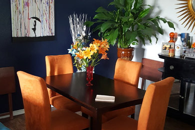 Example of a trendy laminate floor dining room design in Denver with blue walls