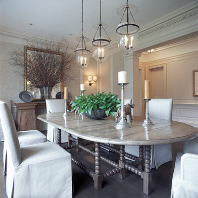 Enclosed dining room - large traditional medium tone wood floor enclosed dining room idea in New York with beige walls