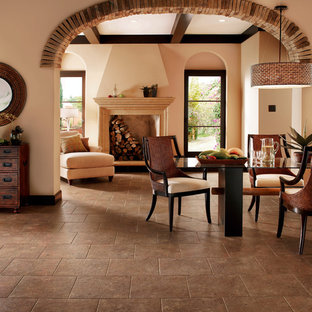 Foto de comedor de estilo americano, grande, abierto, con paredes beige, suelo de baldosas de porcelana, chimenea tradicional, marco de chimenea de madera y suelo marrón