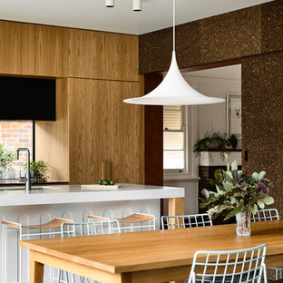 Mid-sized contemporary kitchen/dining combo in Melbourne with concrete floors, grey floor and brown walls.