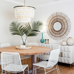 Design ideas for a beach style dining room in Melbourne with white walls, medium hardwood floors and brown floor.