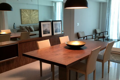 Medium sized modern open plan dining room in Miami with white walls, marble flooring, no fireplace and white floors.