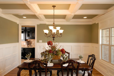 Enclosed dining room - mid-sized traditional medium tone wood floor enclosed dining room idea in Other with green walls