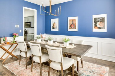 Example of a mid-sized trendy medium tone wood floor kitchen/dining room combo design in Columbus with blue walls