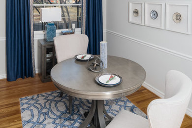 На фото: кухня-столовая среднего размера в стиле неоклассика (современная классика) с серыми стенами, светлым паркетным полом и коричневым полом без камина
