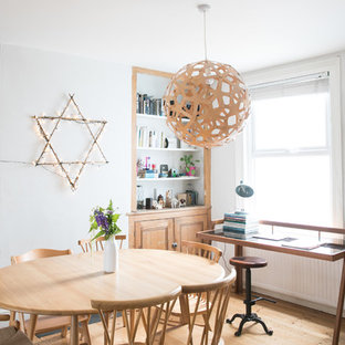 Small contemporary dining room in Other with white walls, light hardwood flooring and beige floors.