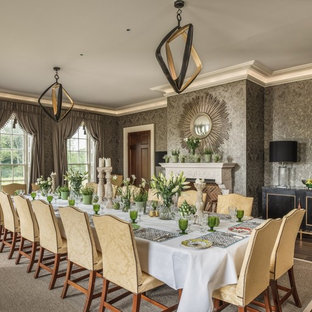 This is an example of a classic dining room in Surrey with grey walls, a standard fireplace and brown floors.