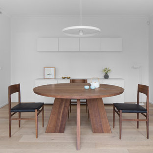 Design ideas for a contemporary dining room in Melbourne with white walls, light hardwood floors and beige floor.