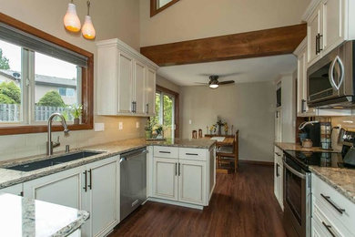 Eat-in kitchen - mid-sized country dark wood floor eat-in kitchen idea in Portland