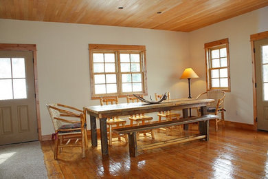 Imagen de comedor rústico de tamaño medio cerrado sin chimenea con paredes blancas, suelo de madera clara y suelo blanco