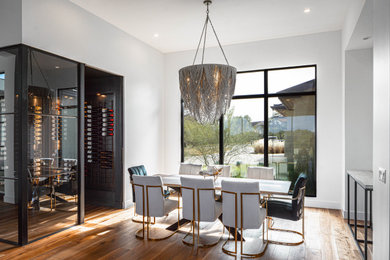 Kitchen/dining room combo - large contemporary medium tone wood floor and brown floor kitchen/dining room combo idea in Austin with white walls