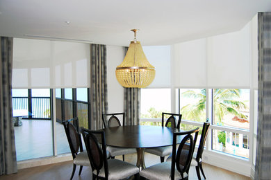 Example of a mid-sized trendy light wood floor kitchen/dining room combo design in Miami with white walls