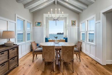 Example of a mid-sized beach style medium tone wood floor and beige floor kitchen/dining room combo design in San Francisco with beige walls and no fireplace