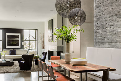 Inspiration for a contemporary open plan dining room in Boston with medium hardwood flooring and feature lighting.