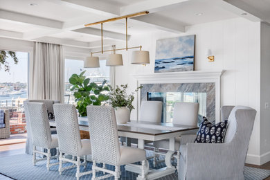 Nautical dining room in Orange County with a coffered ceiling and tongue and groove walls.