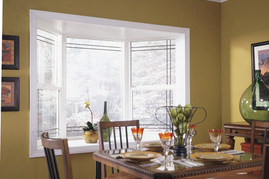 This is an example of a traditional dining room in Dallas with yellow walls.