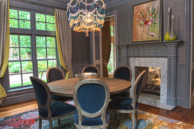 Large traditional enclosed dining room in Other with grey walls, medium hardwood flooring, a two-sided fireplace and a stone fireplace surround.