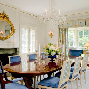 Elegant medium tone wood floor dining room photo in Baltimore with white walls and a standard fireplace