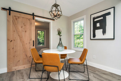 Example of a mid-sized classic laminate floor and gray floor dining room design in New York with gray walls