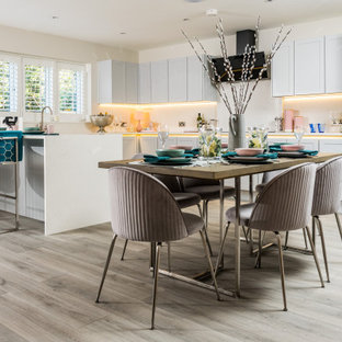 Photo of a contemporary kitchen/dining room in Dorset with beige walls, light hardwood flooring and grey floors.