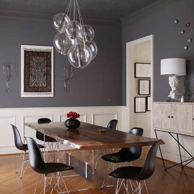 Inspiration for a contemporary medium tone wood floor enclosed dining room remodel in Raleigh with gray walls