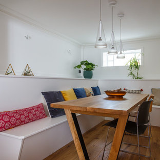 Design ideas for a small contemporary dining room in Sussex with white walls, light hardwood flooring and beige floors.