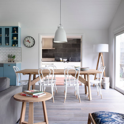 Example of a mid-sized trendy medium tone wood floor great room design in Melbourne with white walls
