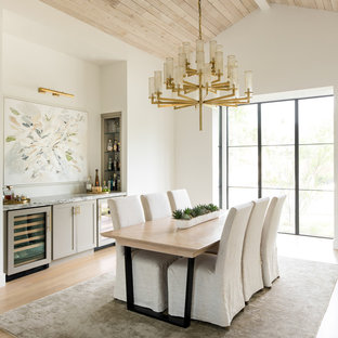 Immagine di una grande sala da pranzo design chiusa con pareti bianche, parquet chiaro, pavimento beige e nessun camino