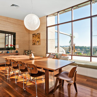 This is an example of a contemporary dining room in Other with brown walls, medium hardwood floors and brown floor.