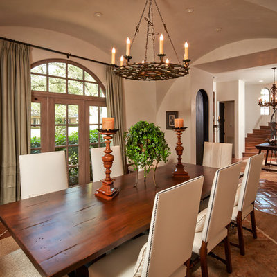 Dining room - mediterranean terra-cotta tile dining room idea in Houston