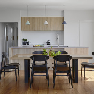 Contemporary kitchen/dining combo in Melbourne with white walls, medium hardwood floors, no fireplace and brown floor.