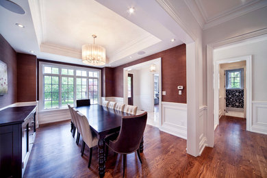 Example of a transitional enclosed dining room design in Toronto with red walls