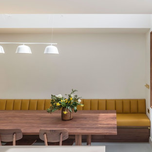Design ideas for a contemporary dining room in Cheshire with white walls, no fireplace and grey floors.