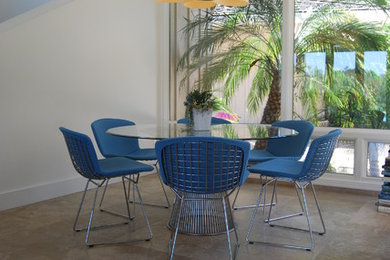 This is an example of a contemporary dining room in San Diego with concrete flooring and white walls.