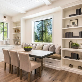 Example of a transitional medium tone wood floor and brown floor dining room design in Los Angeles with white walls