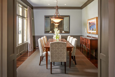 Enclosed dining room - mid-sized traditional dark wood floor enclosed dining room idea in Houston with white walls