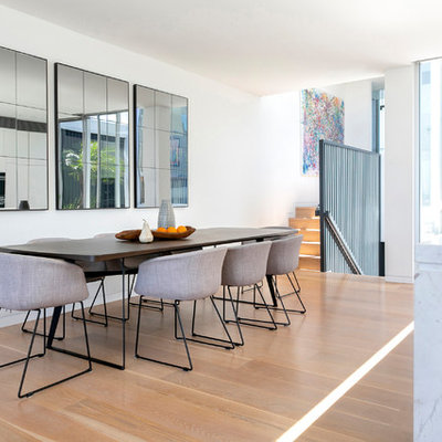 Great room - large contemporary medium tone wood floor and beige floor great room idea in Sydney with white walls